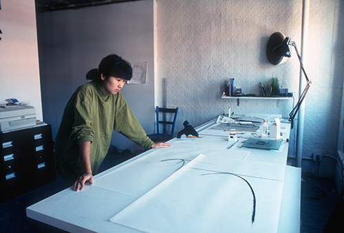 Young woman working at a drafting table
