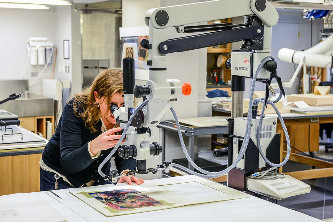 Conservator working on a portrait
