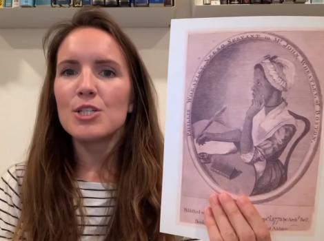 young woman holding an old print