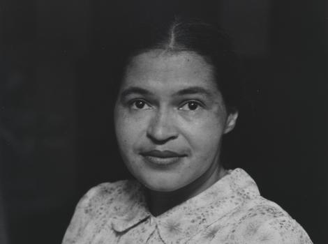 Black and white image of woman wearing white dress and smiling softly