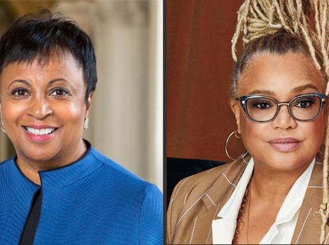 two African American women one with short hair and blue suit one with blond braids 