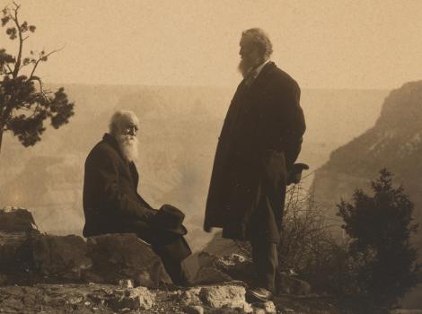 two men standing on the edge of the Grand Canyon